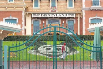  ?? David McNew / AFP / Getty Images ?? Disneyland on the first day of its closure in March. Orange County officials want it to reopen.