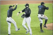  ?? NICK WASS — THE ASSOCIATED PRESS ?? Miami Marlins’ Brian Anderson, center, Eddy Alvarez, left, and Jonathan Villar (2) celebrate after a baseball game against the Baltimore Orioles, Thursday, Aug. 6, 2020, in Baltimore.