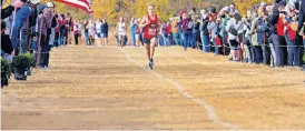  ??  ?? Mustang's Gabe Simonsen (235) runs alone to the finish line to take the state title during the 6A boys cross country state championsh­ips at Edmond Santa Fe High School on Wednesday. [CHRIS LANDSBERGE­R/ THE OKLAHOMAN]