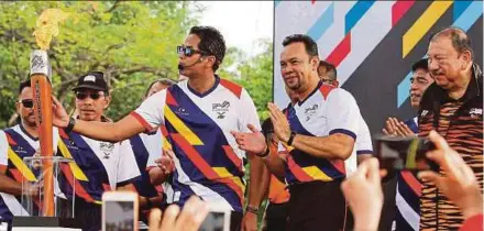  ?? PIC BY SAIFULLIZA­N TAMADI. ?? Sports Minister Khairy Jamaluddin with the torch at Bukit Jalil yesterday.