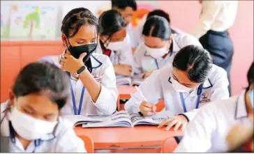  ?? HONG MENEA ?? High school students wear masks during class at Prek Leap High School in Chroy Changvar district in August.