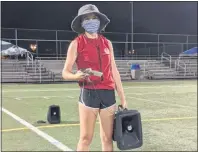  ?? INSTAGRAM: @NORTHPENNB­ANDS ?? North Penn Marching Knights drum major Allie Hershey holds a speaker and wears a mask during a recent rehearsal at North Penn High School.