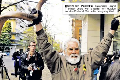  ??  ?? HORN OF PLENTY: Defendant Brand Thornton exults with a ram’s horn outside court in Portland, Ore., after being acquitted.