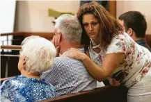  ??  ?? David Temple’s family members react to hearing state District Judge Kelli Johnson declare a mistrial. A new jury will have to convene likely in the spring to determine a punishment.
