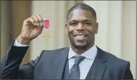  ?? PICTURE: PA WIRE ?? RECOGNITIO­N: Former champion boxer Mark Prince collected an OBE for services to tackling knife and gun crime in London.