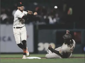 ?? NHAT V. MEYER/BAY AREA NEWS GROUP ?? San Francisco Giants’ Thairo Estrada (39) throws to first base after tagging out San Diego Padres’ Josh Bell (24) at second base on a fielders choice hit by San Diego Padres’ Brandon Drury (17) in the seventh inning at Oracle Park in San Francisco on Monday, Aug. 29, 2022.