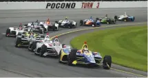  ?? Associated Press ?? ■ Alexander Rossi (27) leads the field through Turn 3 during a restart of the IndyCar auto race Sunday at Pocono Raceway in Long Pond, Pa.