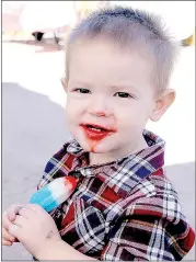  ??  ?? Reece Pierson cools off with a colorful, delicious popsicle during Jane Days.