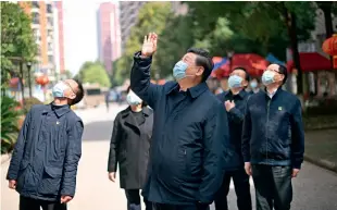  ??  ?? 10 de marzo de 2020. El presidente Xi Jinping visita una comunidad en Wuhan y saluda a los residentes que se mantienen en cuarentena en casa.