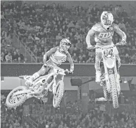  ?? Michael Wyke ?? Cole Seely, left, and Ken Roczen compete in the first heat of the 450SX. The NRG course was set up as a technical track, giving riders obstacles to overcome.