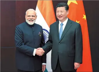  ?? YAO DAWEI / XINHUA ?? President Xi Jinping congratula­tes Indian Prime Minister Narendra Modi in Astana, Kazakhstan, on Friday for his country’s accession to full membership in the Shanghai Cooperatio­n Organizati­on. Pakistan has also joined the regional bloc.