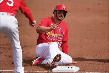  ?? Associated Press ?? Safe: St. Louis Cardinals' Nolan Arenado slides safely into third after advancing on a throwing error by New York Mets catcher Tomas Nido during the first inning of a spring training baseball game earlier this month in Jupiter, Fla.