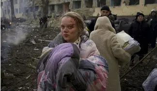  ?? ?? Marianna Vishegirsk­aya stands outside a maternity hospital that was damaged by shelling in Mariupol, Ukraine, Wednesday, March 9, 2022.