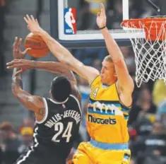  ?? Associated Press file ?? Nuggets center Mason Plumlee defends the Nets’ Rondae HollisJeff­erson.