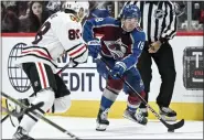  ?? AARON ONTIVEROZ — THE DENVER POST ?? Alex Newhook (18) of the Colorado Avalanche handles as Patrick Kane (88) of the Chicago Blackhawks defends during the first period at Ball Arena in Denver on Wednesday, October 12, 2022.