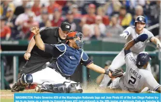  ??  ?? WASHINGTON: Pedro Severino #29 of the Washington Nationals tags out Jose Pirela #2 of the San Diego Padres trying to go home on a single by Franmil Reyes #32 (not pictured) in the fifth inning at Nationals Park on Tuesday in Washington. — AFP