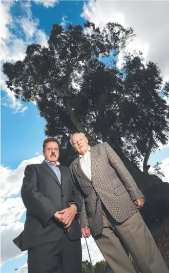  ?? Picture: HAMISH BLAIR ?? Cr Geoff Gough with 94-year-old Nevin Phillips in front of the historic red gum in Bulleen in Victoria. The tree could be uprooted to make way for a road.