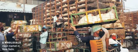  ??  ?? A WHOLESALE meat market in New Delhi.