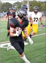  ?? TIMES photograph­s by Annette Beard ?? Senior wide receiver Will Anderson, No. 11, maintains a tight grasp on the football while making his way towards the end zone Friday, Sept. 10.