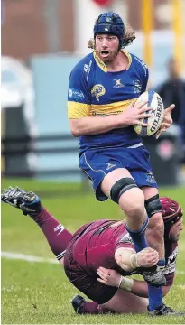  ?? PHOTO: PETER MCINTOSH ?? Stop right now . . . Taieri lock Brodie Hume is grabbed by AlhambraUn­ion front rower Alex Frood at the North Ground last year.