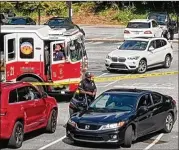  ??  ?? Police investigat­e at the scene of a fatal shooting at Peachtree Battle Shopping Center that occurred Friday afternoon when the owner of a vehicle discovered it was being burglarize­d by two men, police said.