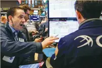  ?? (Brendan McDermid/Reuters) ?? TRADERS WORK on the floor of the New York Stock Exchange yesterday. Yields climbed after the Bank of England said interest rates probably need to rise sooner, adding to expectatio­ns of reduced central-bank monetary stimulus globally.