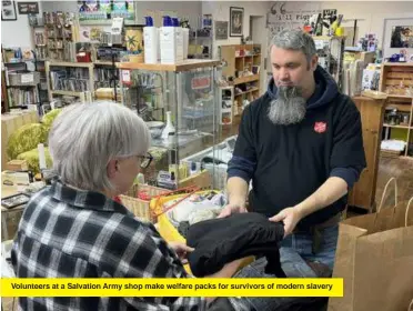  ?? ?? Volunteers at a Salvation Army shop make welfare packs for survivors of modern slavery