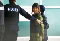  ??  ?? VIETNAMESE Doan Thi Huong who is on trial for the killing of Kim Jong-Nam, the estranged half-brother of North Korea’s leader, is escorted as she arrives at the Department of Chemistry in Petaling Jaya, near Kuala Lumpur, Malaysia Oct. 9.