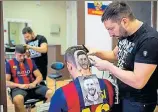  ?? AFP ?? ■ Craze for the Messi hair tattoo has caught on in Serbia.