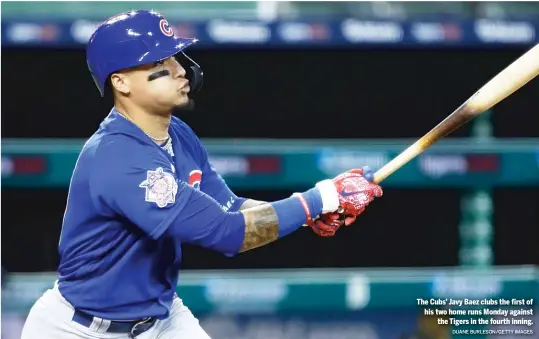  ?? DUANE BURLESON/GETTY IMAGES ?? The Cubs’ Javy Baez clubs the first of his two home runs Monday against the Tigers in the fourth inning.