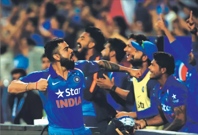  ?? Reuters ?? Virat Kohli celebrates after Hardik Pandya and R Ashwin take the team over the line against England in Pune on Sunday.