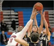  ??  ?? Stephan Tucker (L) battles for a rebound in duel with CR South.