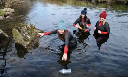  ?? ?? Surfers Against Sewage representa­tives collecting litter in the Afon Glaslyn in Snowdonia. Photograph: Rui Vieira/PA