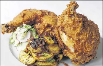  ?? CONTRIBUTE­D BY ?? Fried pastured organic chicken, fingerling potato salad and Napa slaw at Table & Main in Roswell. This is one of the specialtie­s at the popular “Southern tavern.”