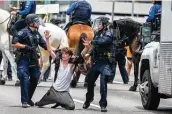  ?? Ricardo B. Brazziell / Associated Press ?? Austin police arrest a protester as they shut down southbound Interstate 35. Demonstrat­ors were protesting the death of George Floyd.