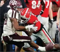  ?? AP/JOHN BAZEMORE ?? Texas A&M running back Isaiah Spiller (left) can’t hang on to a pass as he is hit by Georgia linebacker Tae Crowder in the second half Saturday in Athens, Ga. Georgia won 19-13.