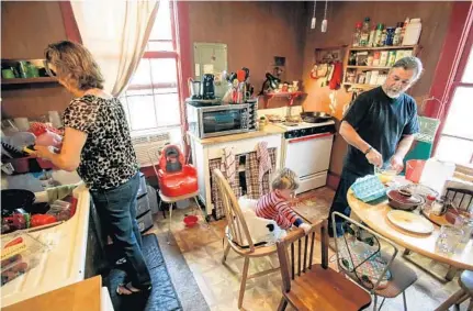  ?? JACOB LANGSTON/STAFF PHOTOGRAPH­ER ?? Mike and Lynne Belisle prepare breakfast at their home — as Mike also keeps an eye on 11⁄2-year-old Nicholas. The families of Daniel and Heather Kelsey agreed it would be best for the Belisles, who live near Tallahasse­e, to raise Nicholas and his...