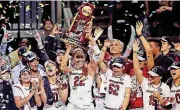  ?? [AP PHOTO] ?? South Carolina forward A’ja Wilson holds the trophy as she and teammates celebrate their win over Mississipp­i State in the NCAA women’s national championsh­ip game on Sunday in Dallas.