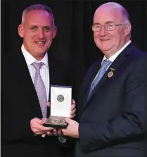  ??  ?? Colm Corrigan, left, of LMFM with the award for Best GAA related Radio Programme for LMFM’s “When Sam crossed the Boyne”, with Uachtarán Chumann Lúthchleas Gael John Horan presenting the award.