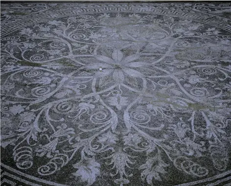  ??  ?? A restored mosaic floor inside a banquet room of the palace at Aigai. The elaborate botanical motif was created with beach pebbles of various
shades.