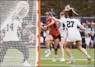  ?? David Stewart / Hearst Connecticu­t Media ?? New Canaan’s Devon Russell (8) takes a shot against Wilton goalie Amelia Hughes while defended by Catherine Dineen (3) and Whitney Hess (27) on April 13.