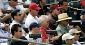  ?? CHARLIE RIEDEL — THE ASSOCIATED PRESS FILE ?? In this file photo, baseball scouts use radar guns to read the speed of a pitch during a spring training baseball game between the Florida Marlins and the Washington Nationals in Jupiter, Fla. Longtime baseball men who once hit the road ahead of their...