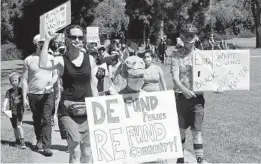  ?? NELVIN C. CEPEDA U-T ?? About 200 people march around La Mesita Park in La Mesa for a children-geared protest in support of Black Lives Matter on Saturday.