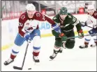  ??  ?? Colorado Avalanche’s Brandon Saad (20) handles the puck in front of Minnesota Wild’s Kevin Fiala (22) during the second period of an NHL hockey game on April 7, in St Paul, Minn. (AP)