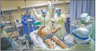  ?? (File Photo/AP/John Minchillo) ?? Nurses and doctors clear the area before defibrilla­ting a patient with covid-19 who went into cardiac arrest on April 20 at a hospital in Yonkers, N.Y. The emergency room team successful­ly revived the patient.