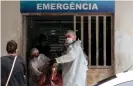  ?? Photograph: Marcio James/AFP/Getty Images ?? Health workers bring a patient in the Emergency room of the public hospital in Manacapuru, Amazonas state, on 20 January.