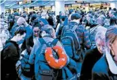  ?? ELIZABETH PULVERMACH­ER VIA AP ?? Thousands of travelers wait Saturday in a coronaviru­s screening line at O’Hare Internatio­nal Airport in Chicago.