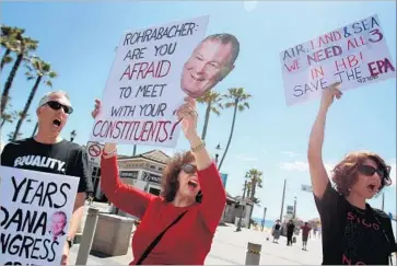  ?? Luis Sinco Los Angeles Times ?? DEMONSTRAT­ORS on April 18 stage a protest calling on Rep. Dana Rohrabache­r (R-Huntington Beach) to hold a town hall meeting. More than a dozen resistance groups have formed in Orange County since November.