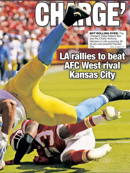  ?? Getty Images; AP ?? NOT ROLLING OVER: The Chargers’ Gabe Nabers flips over the Chiefs’ Anthony Hitchens in LA’s surprising 3024 win over powerful Kansas City.