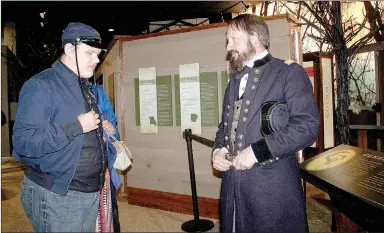  ?? LYNN KUTTER ENTERPRISE-LEADER ?? Jim Spillars, portraying General James Blunt, talks to Coby Turney of Lincoln about the Battle of Prairie Grove. Coby was attending the state park’s first Night at the Museum.